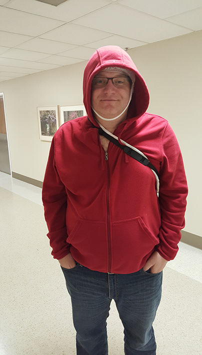 Our host of The Brain Ablaze Epilepsy Podcast, David Clifford wears a hoodie over an EEG sensor array during an ambulatory EEG.