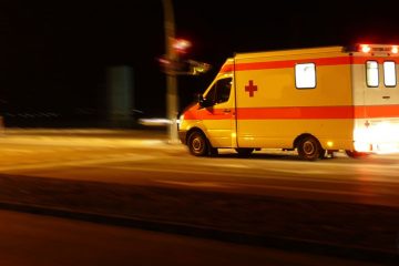 An ambulance races through the night.